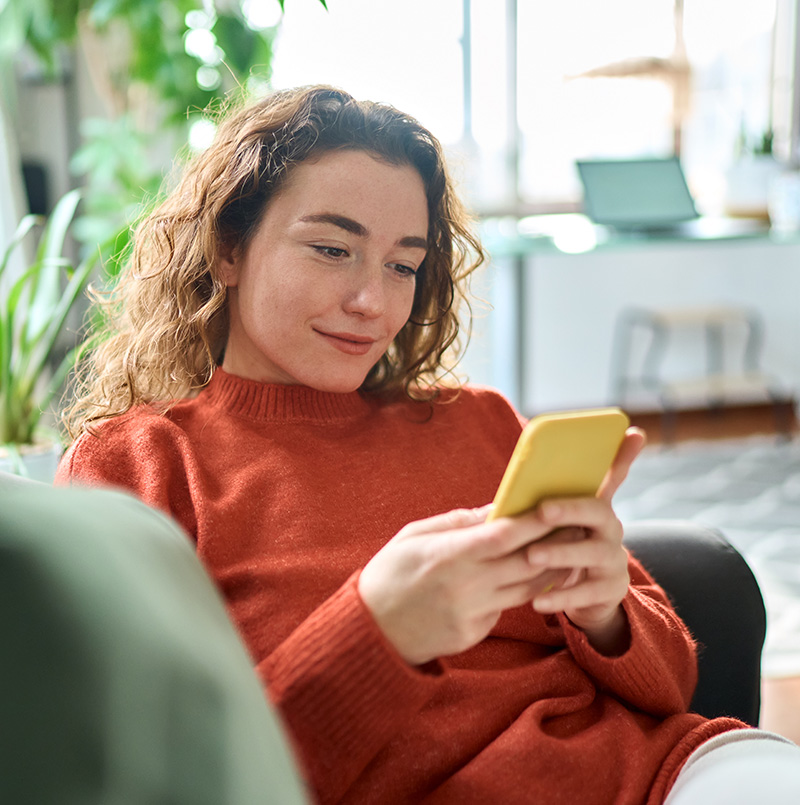 faqs woman on a phone looking happy